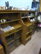 An Arts and Crafts oak display cabinet, maker`s plate inside reads J Waring & Sons ( Waring &