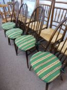 A set of four Ercol dining chairs being dark oak spindled back, stamped BS LH 960 2056 to the