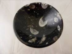 A shallow bowl made from pagoda stone with orthoceras inclusions,12 x 5 x 12 cms.