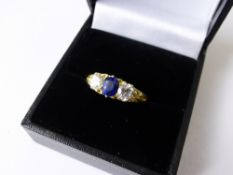 A Lady`s 18 ct Yellow Gold Sapphire and Diamonds Ring, the sapphire and diamonds set in a scroll