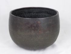 An Antique Oriental Bronze Hammered Pot, with floral decoration to the top outside edge.