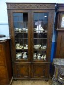 An Oak Edwardian Display Cabinet, three shelves, with two cupboards beneath, the doors fitted with