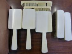A Vintage Ivory Dressing Table Set, comprising hairbrush, hand mirror, two combs and two clothes