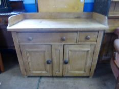 An antique pine sideboard having a gallery to the sides and back, fitted with one long and one