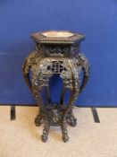 An Antique Chinese Hardwood Torchere, the hexagon torchere with decorative foliate carving to the