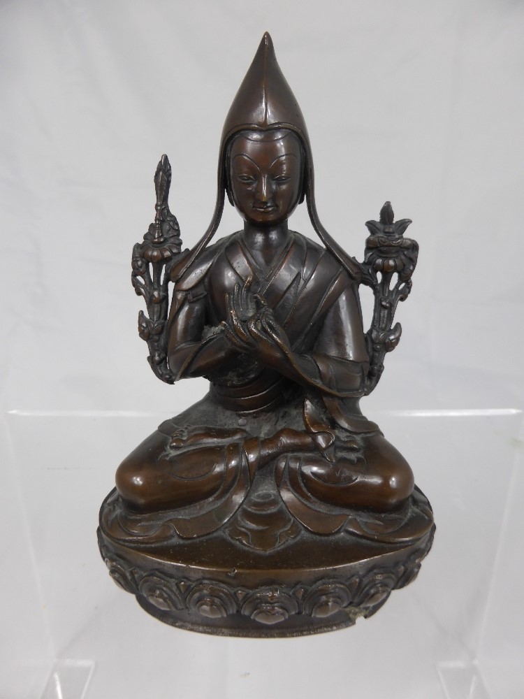 A Sino -Tibetan figure of Buddha, the bronzed figure seated with hands clasped on a lotus form