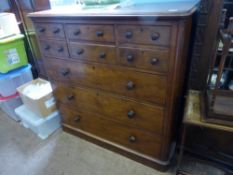 A Victorian Maples of London Chest of Drawers, the chest with two short drawers and a central hat