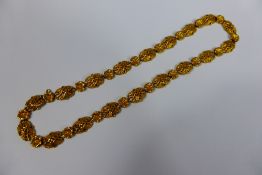 An 18 ct Gold Tested Necklace, the necklace consisting of floral and laurel links with double clasp