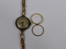 A Miscellaneous Collection of Gold including two 9 ct wedding rings and gold cased ladies watch.