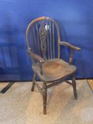 A Child`s Wheel Back Windsor Chair, with turned legs and supports.