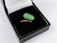 A Lady`s 14 ct Yellow Gold oval Jade stone ring, with bamboo form shank, size M, approx 3.5 gms.