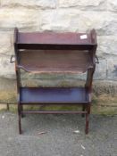 An Edwardian mahogany book shelf / magazine rack having a carrying handle to each end, approx. 50 x