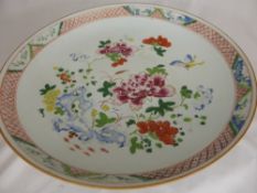 A 19th Century Famille Rose Plate, depicting peony and butterflies, 36 cms diameter, red ceramic