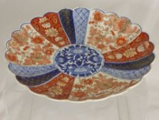 Antique Imari Plate, with fluted segments and gilt highlights.