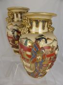 Pair of satsuma vases having relief design depicting geisha with dogs of fo to the neck, approx. 31