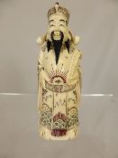 Carved oriental bone figure depicting a wise man holding a scroll, character mark to the base