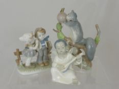 Porcelain Lladro Figures, including a squirrel, a seated angel and two little children.