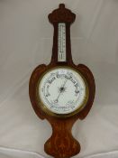 An Edwardian Aneroid Barometer, in a mahogany fame with scroll inlay.