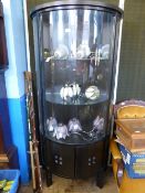 Modern bow fronted display cabinet having glass doors to the front with glass panels to the sides,