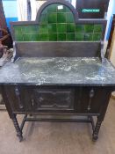 Edwardian Oak Wash Stand, with a grey marble top and a green tile back.