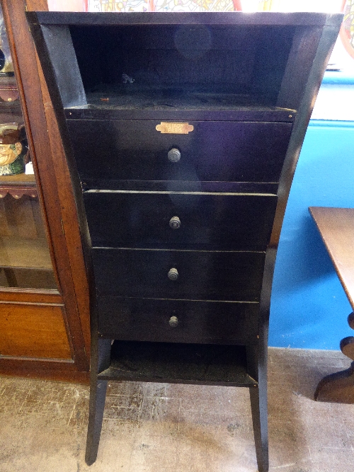 French art deco style ebonised chest of drawers by Celton, Paris having four drawers with an open