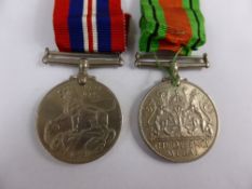 Two WWII Service Medals, The Defence Medal and the 1939-45 War Medal.