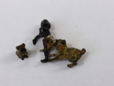 An antique miniature cold cast bronze figure of a boy, together with a miniature bronze of a Pug.