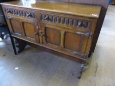 Old Charm style  oak sideboard having two drawers with cupboards below, supported on a single