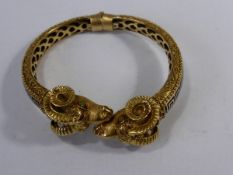 An Ornate 18 ct Yellow Gold and Enamel Ram`s Head Spring Bracelet having blue enamel geometric
