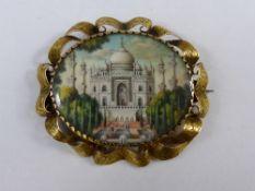 An antique Indian hand painted miniature gold and ivory pin brooch depicting the Taj Mahal set in