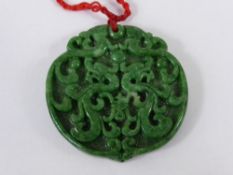 A Green Jade Pendant, depicting entwined dragons.