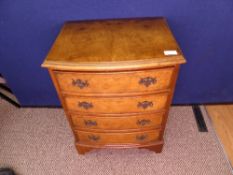 Small Victorian walnut bow fronted chest of drawers on bracket feet with four small drawers,