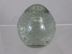 Large clear glass paperweight having bubble inclusions, approx.37 cms. circumference