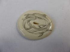 Ivory Scrimshaw Button, depicting entwined dolphins, 42 x 35 mm, signed Uli.