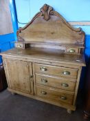 Vintage waxed pine sideboard having a shaped top with foliate decoration to the top and corners