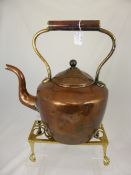 A Large 19th Century Copper Fireside Kettle, together with a brass trivet.