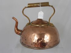 An Antique Flat Bottomed Copper Kettle, with brass handle.