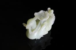 Chinese Qing Dynasty Celadon Jade Carving of a Seated Bird, the crested bird features carved feet