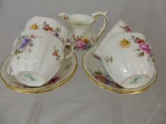 A part Royal Crown Derby `Roses` Tea Set comprising two milk jugs, six cups and saucers, one