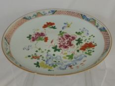 Chinese Famille Rose Plate, depicting figures in a garden room, with flowers butterflies and peony.