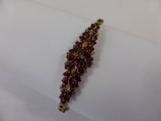 Lady`s 14 ct Yellow Gold Ruby and Diamond Cocktail Bracelet, the cluster set bracelet having 54