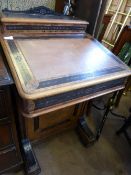 Victorian maple davenport having ebonised and carved decoration to the top and surrounds, four