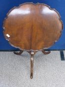 Reproduction mahogany tilt top occasional table being scallop edged on hoof feet, approx. 61 cms.