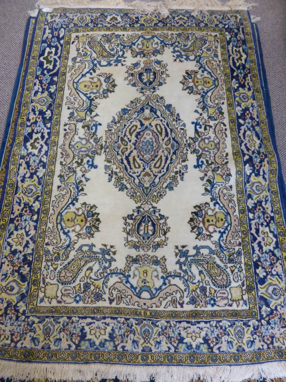 A Persian Carpet, with blue and gold floral design on cream ground approx 170 x 110cms