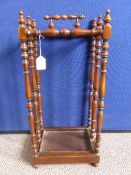 Victorian Mahogany stick stand with turned supports and original tray.