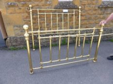Reproduction brass bed comprises a head end and a feet end, both having spindles with decoration to
