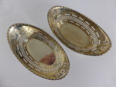 A Pair of Oval Solid Silver Trinket Dishes, the dishes with decorative piercing to the sides,