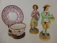 Two English porcelain figures of a gentleman and lady selling fruit, No. A227 stamped to base,
