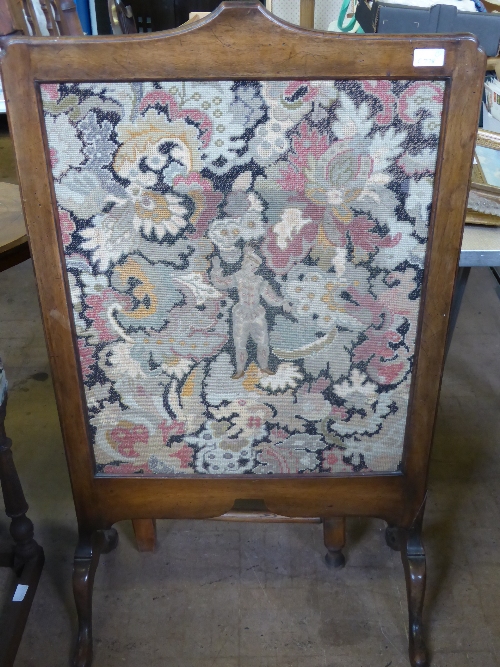 Vintage mahogany framed fire screen, the embroidery depicting a young man amidst a foliate