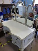 Serpentine fronted cream and gilt wood dressing table having triple mirrors to the top, two drawers